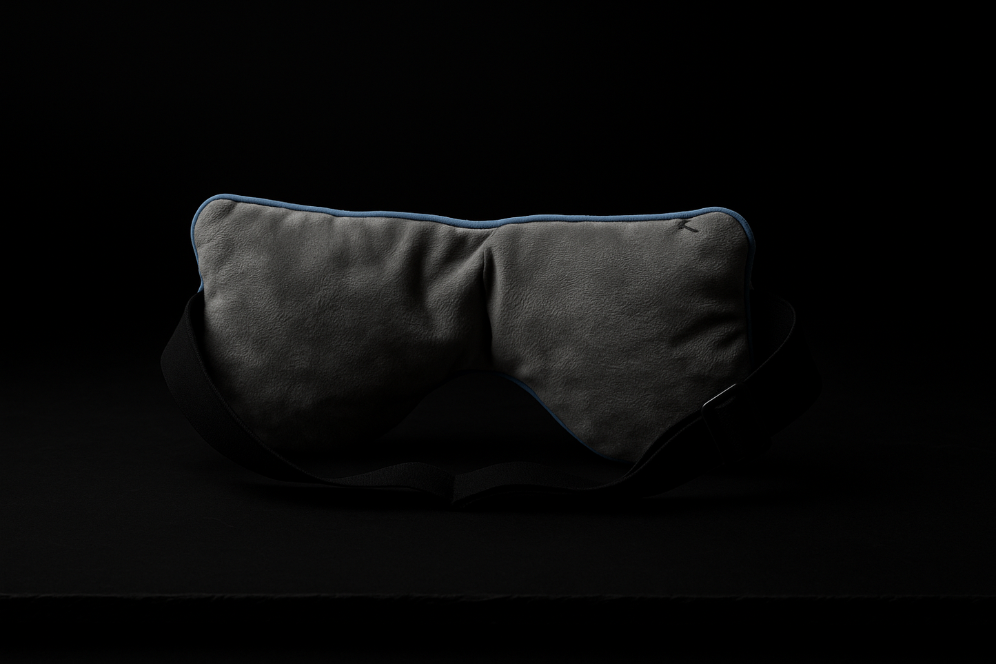 Back view of luxury weighted sleep mask on black background highlighting adjustable strap and ultra-soft inner lining